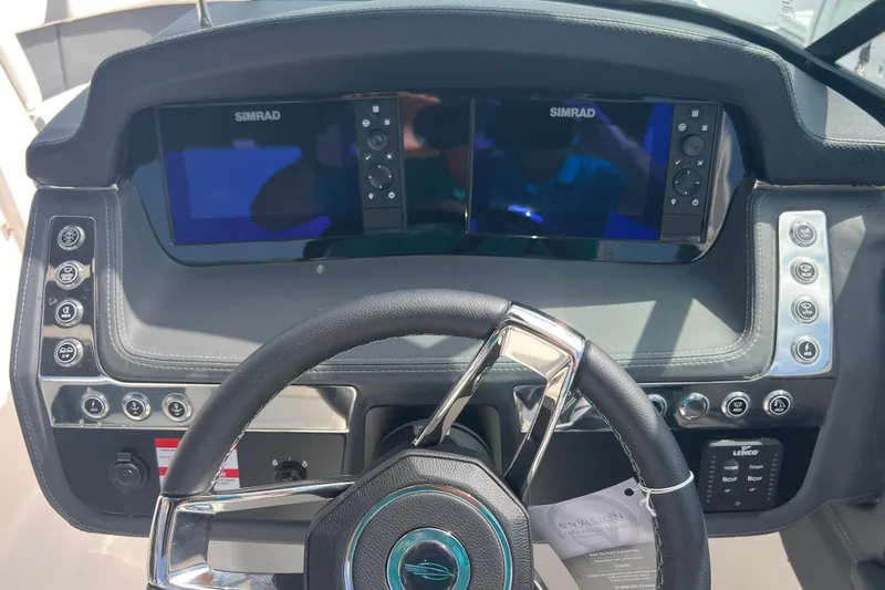  Yacht Photos Pics 2025 Chaparral 270 OSX dashboard with dual Simrad displays and modern steering wheel.