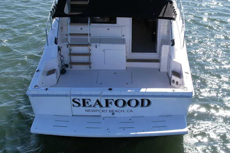 Seafood (reserved) Yacht Photos Pics Riviera 43 Open Flybridge 1998 boat with "SEAFOOD" signage, Newport Beach, CA.