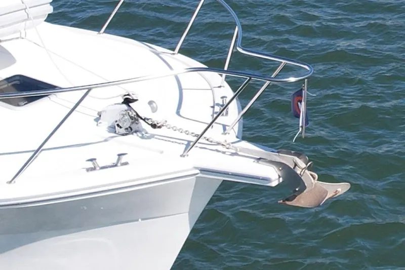 Seafood (reserved) Yacht Photos Pics 1998 Riviera 43 Open Flybridge yacht bow with anchor and railing on water.