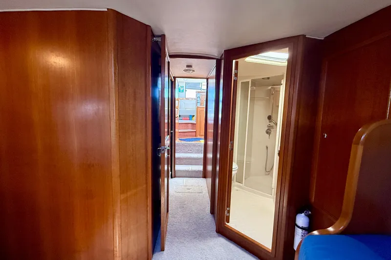 Seafood (reserved) Yacht Photos Pics Interior view of 1998 Riviera 43 Open Flybridge yacht, featuring wooden paneling and a bathroom.