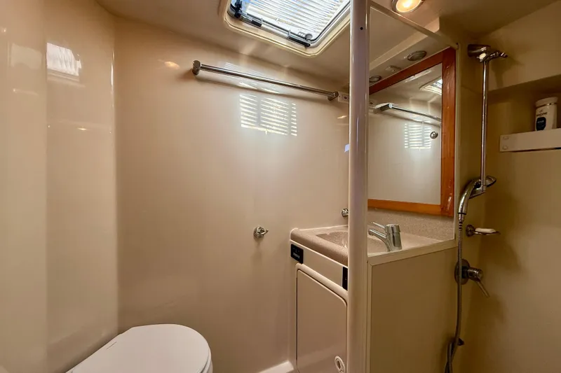 Seafood (reserved) Yacht Photos Pics Bathroom interior of 1998 Riviera 43 Open Flybridge yacht, featuring sink and shower.