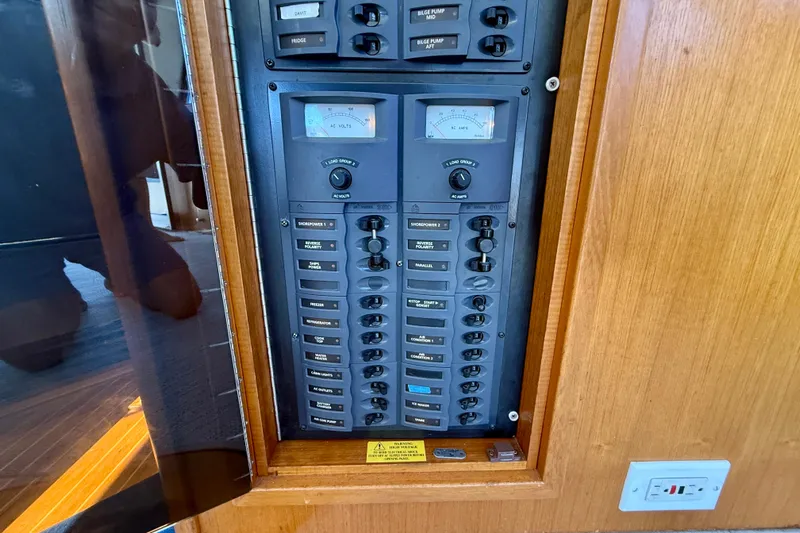 Seafood (reserved) Yacht Photos Pics Electrical panel of 1998 Riviera 43 Open Flybridge yacht, featuring various switches and meters.