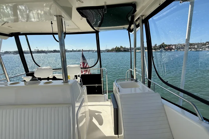 Seafood (reserved) Yacht Photos Pics 1998 Riviera 43 Open Flybridge yacht interior with ocean view and American flag.