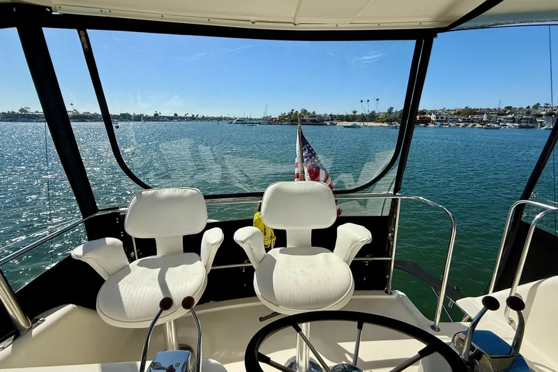 Seafood (reserved) Yacht Photos Pics 1998 Riviera 43 Open Flybridge yacht interior with ocean view and steering wheel.