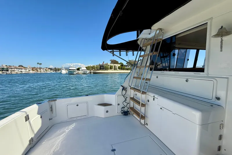 Seafood (reserved) Yacht Photos Pics 1998 Riviera 43 Open Flybridge yacht with spacious deck and marina view.