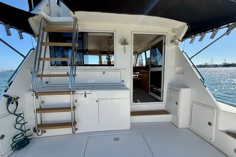 Seafood (reserved) Yacht Photos Pics 1998 Riviera 43 Open Flybridge yacht interior with stairs and ocean view.