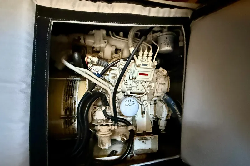 Seafood (reserved) Yacht Photos Pics Engine compartment of a 1998 Riviera 43 Open Flybridge boat, showcasing mechanical components.