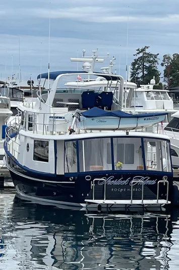 Sherlock Holmes Yacht Photos Pics Kadey-Krogen 44E yacht, 2016 model, docked at marina with calm water reflections.