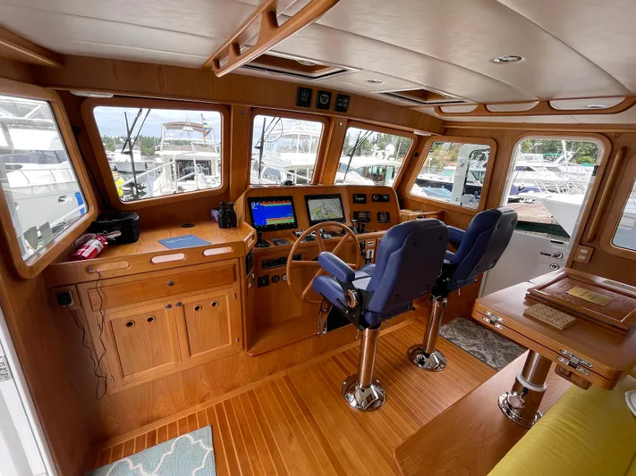 Sherlock Holmes Yacht Photos Pics Interior of 2016 Kadey-Krogen 44E yacht with wooden helm and navigation equipment.
