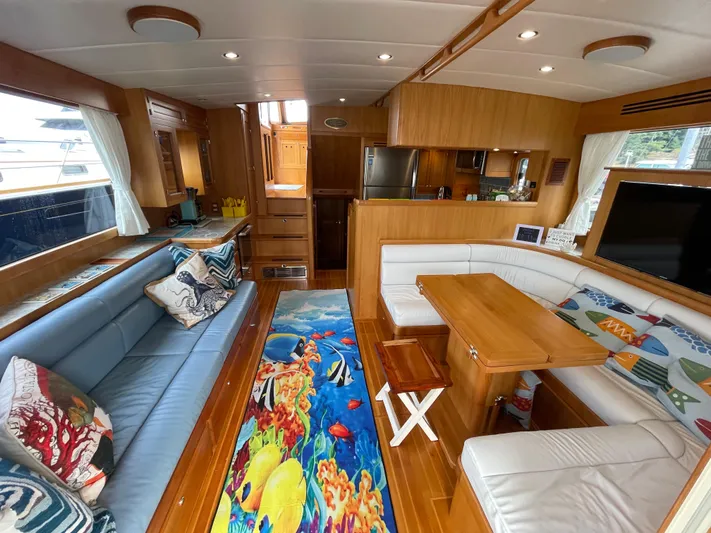 Sherlock Holmes Yacht Photos Pics Luxurious 2016 Kadey-Krogen 44E yacht interior with cozy seating and vibrant marine-themed decor.