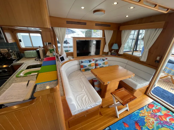 Sherlock Holmes Yacht Photos Pics Luxurious 2016 Kadey-Krogen 44E yacht interior with cozy seating, dining table, and modern kitchen.