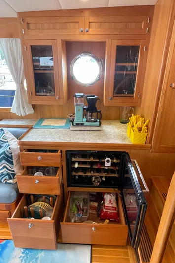 Sherlock Holmes Yacht Photos Pics Interior of 2016 Kadey-Krogen 44E yacht with kitchen storage and wine cooler.