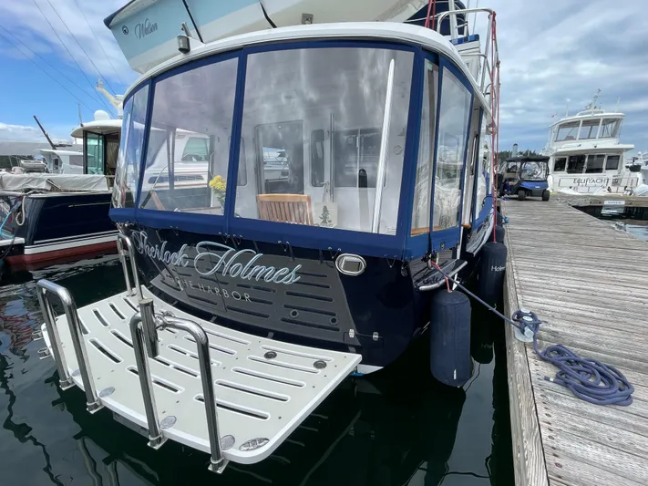 Sherlock Holmes Yacht Photos Pics Kadey-Krogen 44E 2016 yacht docked, featuring a spacious rear deck and elegant design.
