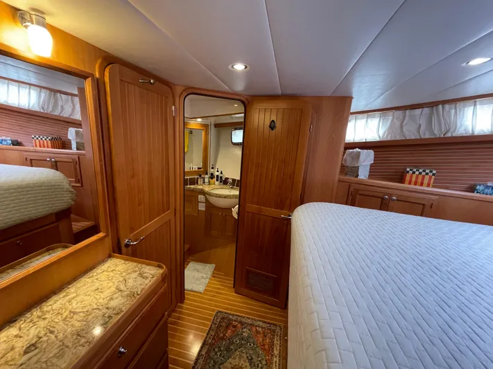 Sherlock Holmes Yacht Photos Pics Luxurious 2016 Kadey-Krogen 44E yacht interior with wood paneling and cozy bedroom.