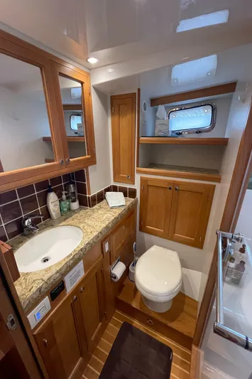 Sherlock Holmes Yacht Photos Pics Luxurious bathroom in 2016 Kadey-Krogen 44E yacht with wooden cabinets and granite countertop.