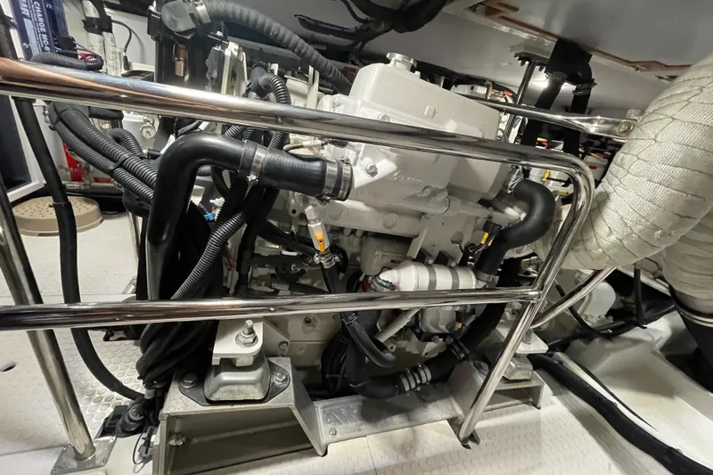 Sherlock Holmes Yacht Photos Pics Engine room of 2016 Kadey-Krogen 44E yacht, showcasing complex machinery and piping.