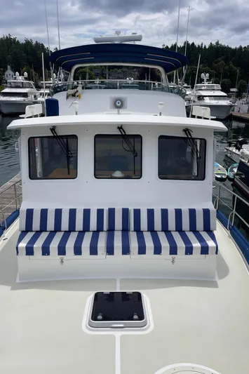 Sherlock Holmes Yacht Photos Pics Kadey-Krogen 44E 2016 yacht with striped seating, docked in a marina.