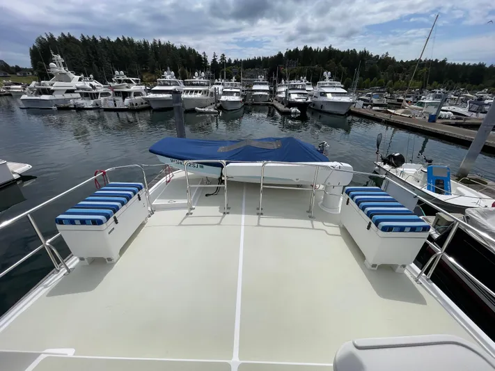 Sherlock Holmes Yacht Photos Pics Kadey-Krogen 44E 2016 yacht deck with striped seating, docked at marina.