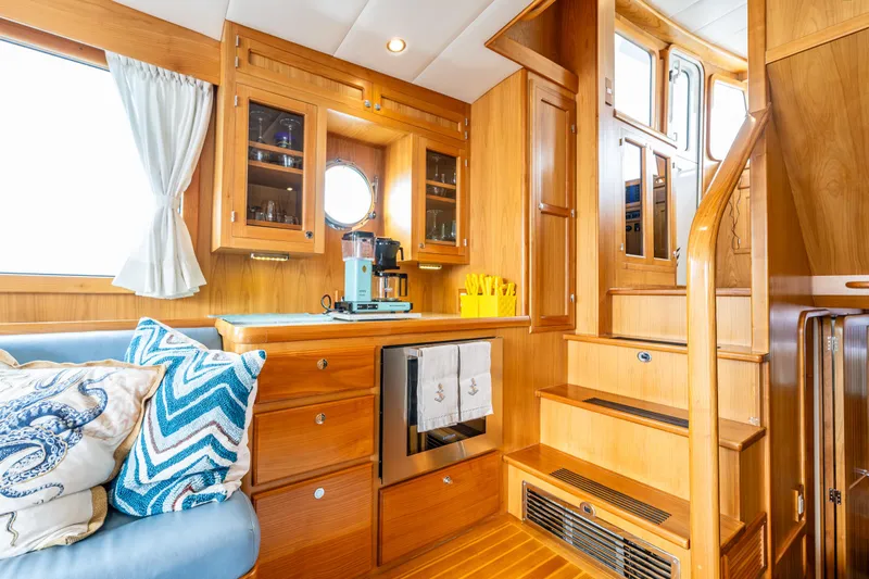 Sherlock Holmes Yacht Photos Pics Luxurious interior of 2016 Kadey-Krogen 44E yacht with wooden cabinetry and cozy seating.