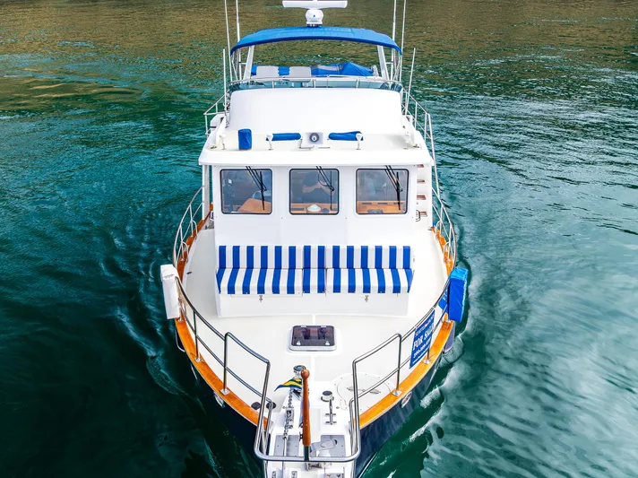 Sherlock Holmes Yacht Photos Pics Kadey-Krogen 44E 2016 yacht on water, featuring blue and white striped seating.