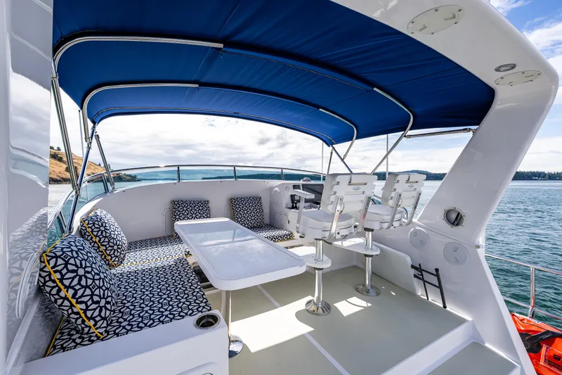 Sherlock Holmes Yacht Photos Pics Luxurious 2016 Kadey-Krogen 44E yacht deck with blue canopy and stylish seating.