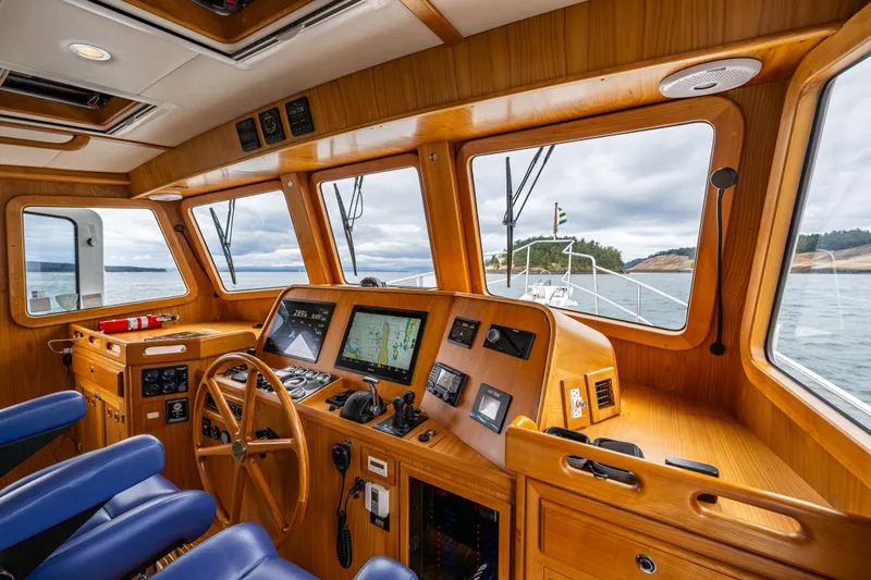 Sherlock Holmes Yacht Photos Pics Pilothouse interior of 2016 Kadey-Krogen 44E yacht with navigation equipment and ocean view.