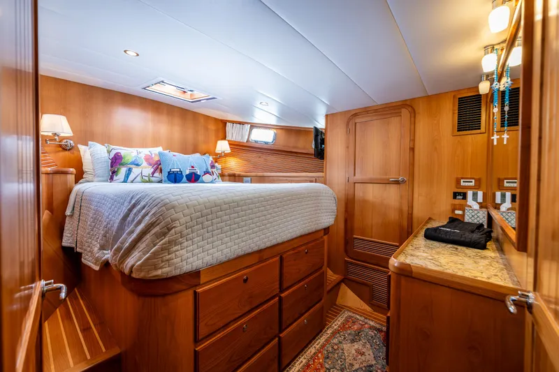 Sherlock Holmes Yacht Photos Pics Luxurious 2016 Kadey-Krogen 44E yacht bedroom with wood finish and cozy bedding.