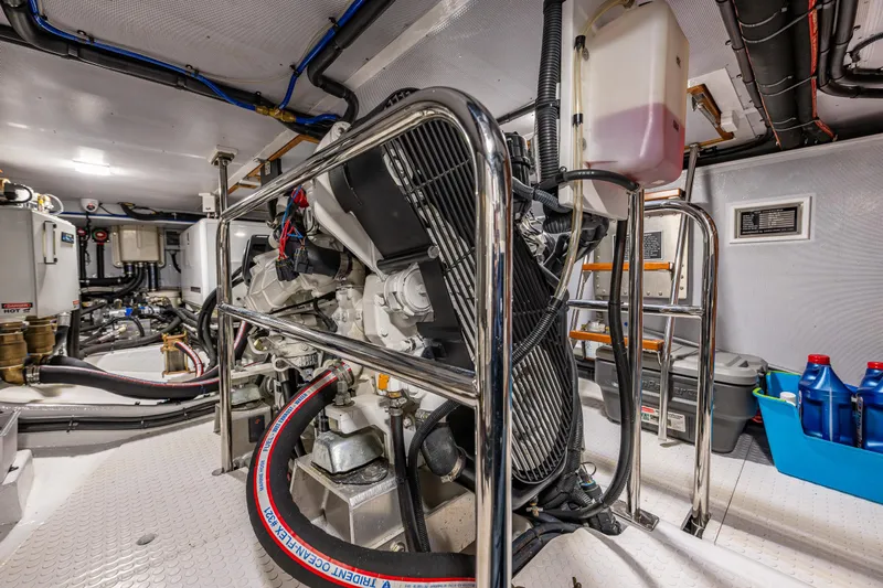 Sherlock Holmes Yacht Photos Pics Engine room of 2016 Kadey-Krogen 44E yacht, featuring machinery and storage containers.