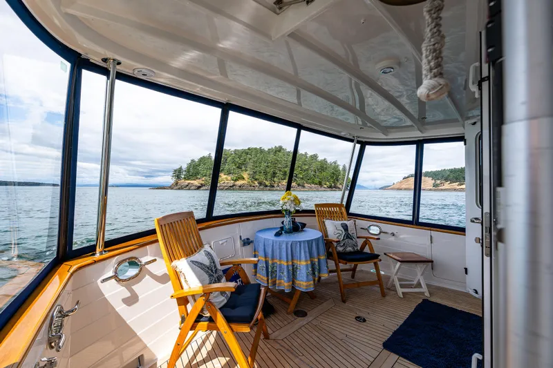 Sherlock Holmes Yacht Photos Pics Kadey-Krogen 44E yacht interior with ocean view, featuring a cozy seating area, 2016 model.