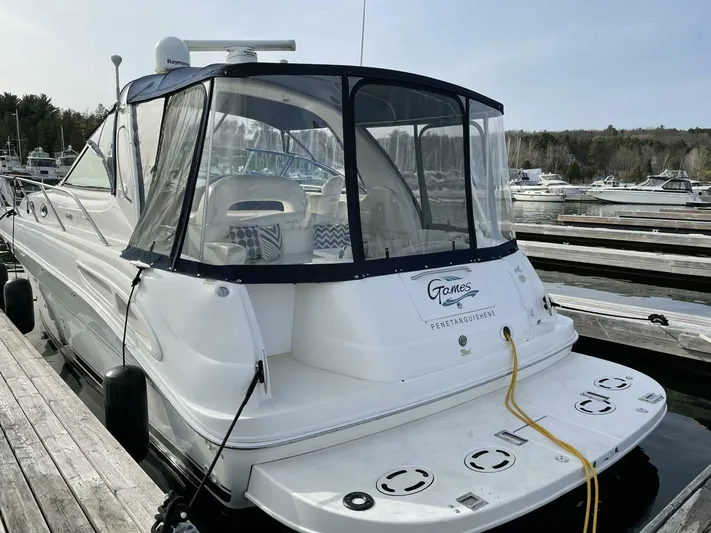  Yacht Photos Pics 2001 Sea Ray 410 Express Cruiser docked at marina, rear view with clear canopy.