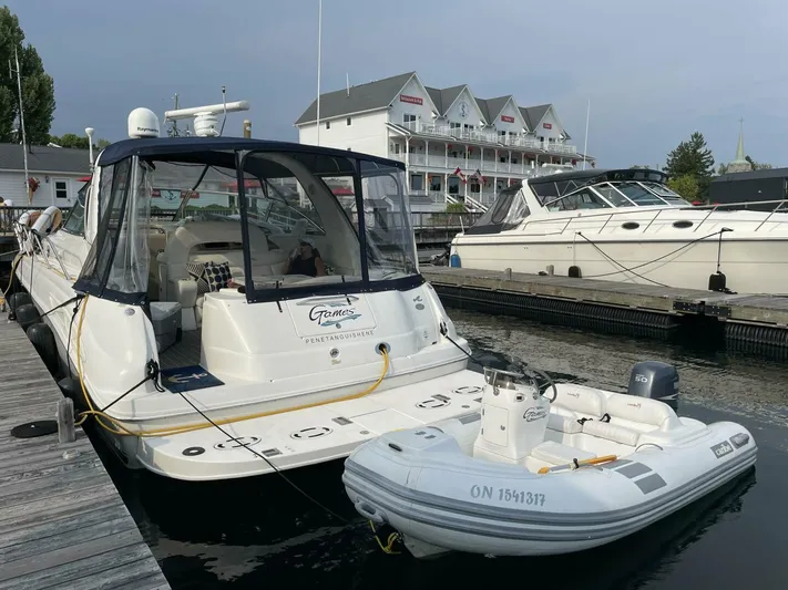  Yacht Photos Pics 2001 Sea Ray 410 Express Cruiser docked with inflatable boat, marina backdrop.