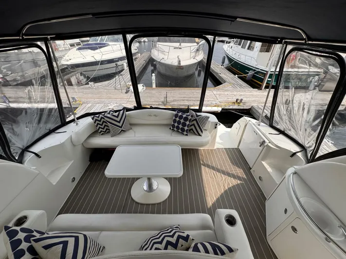  Yacht Photos Pics 2001 Sea Ray 410 Express Cruiser interior with seating, table, and marina view.