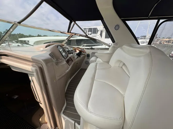  Yacht Photos Pics 2001 Sea Ray 410 Express Cruiser interior with beige seating and helm controls.