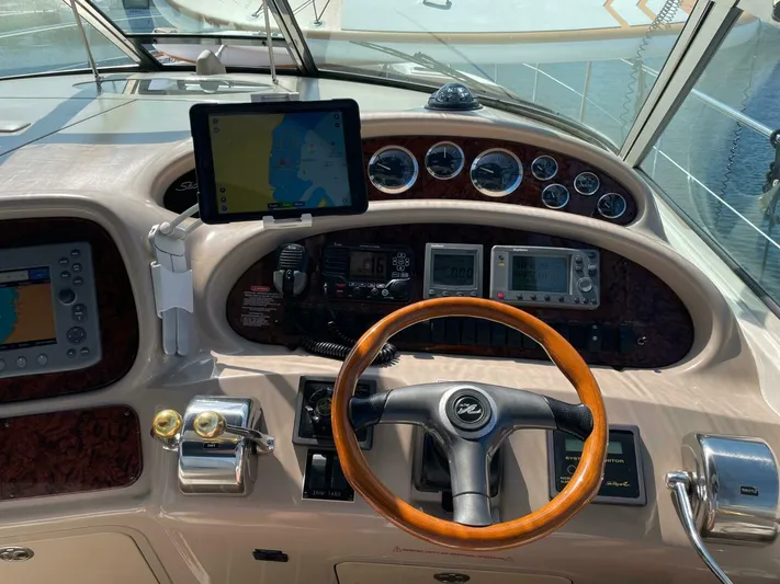  Yacht Photos Pics Control panel of a 2001 Sea Ray 410 Express Cruiser with navigation equipment and steering wheel.