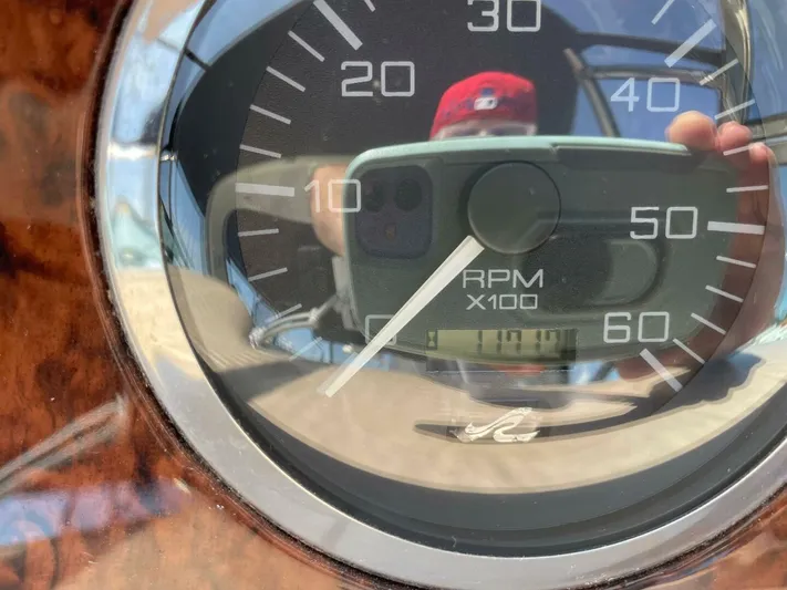  Yacht Photos Pics Close-up of a Sea Ray 410 Express Cruiser 2001 RPM gauge reflecting a person taking a photo.