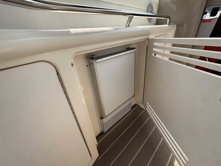  Yacht Photos Pics 2001 Sea Ray 410 Express Cruiser interior with built-in mini fridge and storage.