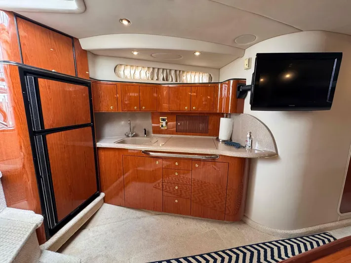  Yacht Photos Pics Luxurious kitchen interior of 2001 Sea Ray 410 Express Cruiser with wood cabinetry and modern amenities.