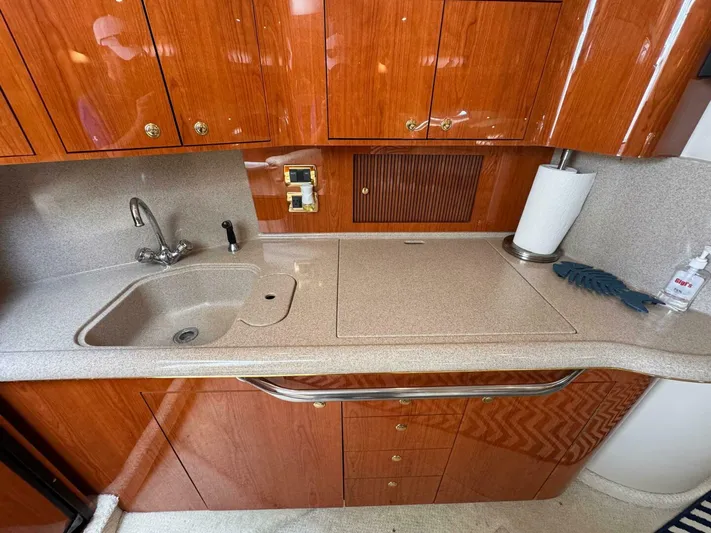  Yacht Photos Pics 2001 Sea Ray 410 Express Cruiser kitchen with wooden cabinets and countertop sink.