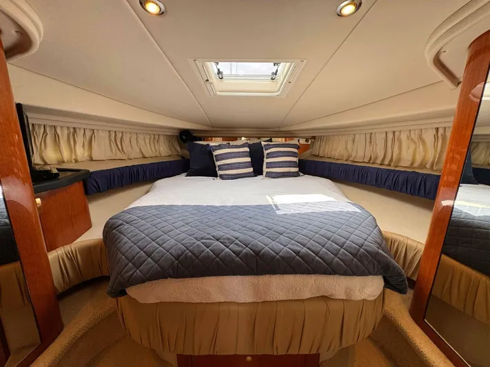  Yacht Photos Pics Luxurious cabin interior of 2001 Sea Ray 410 Express Cruiser with cozy bedding.