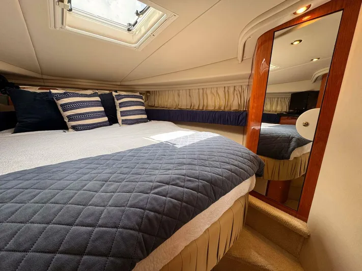  Yacht Photos Pics Luxurious cabin interior of 2001 Sea Ray 410 Express Cruiser with cozy bedding and mirror.