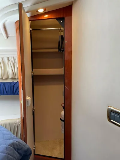  Yacht Photos Pics Interior of 2001 Sea Ray 410 Express Cruiser with mirrored closet and cozy cabin features.