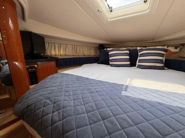  Yacht Photos Pics Luxurious cabin interior of 2001 Sea Ray 410 Express Cruiser with cozy bedding and natural light.