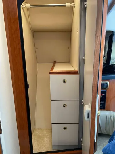  Yacht Photos Pics 2001 Sea Ray 410 Express Cruiser interior closet with drawers and hanging space.