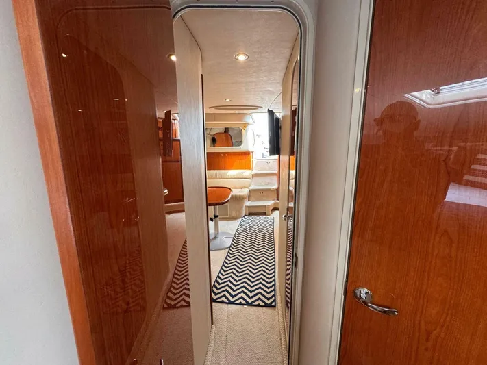  Yacht Photos Pics Interior of 2001 Sea Ray 410 Express Cruiser with wood paneling and chevron rug.