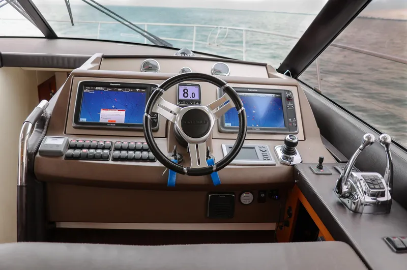  Yacht Photos Pics Cockpit of 2015 Prestige 520 yacht with modern navigation controls and ocean view.
