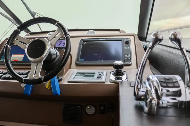  Yacht Photos Pics Cockpit of 2015 Prestige 520 yacht with steering wheel and navigation controls.