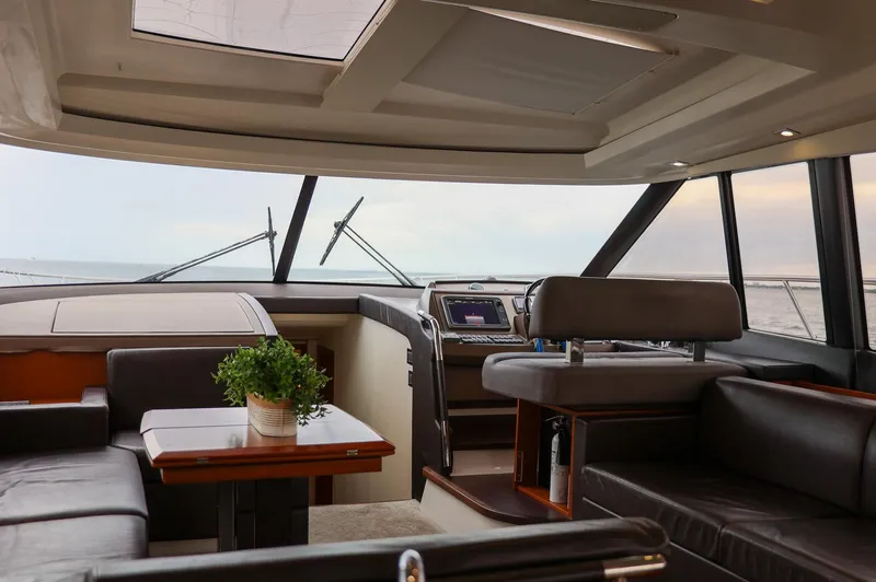  Yacht Photos Pics Luxurious interior of a 2015 Prestige 520 yacht with modern seating and navigation area.