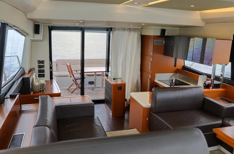  Yacht Photos Pics Luxurious interior of a 2015 Prestige 520 yacht with modern furnishings and outdoor seating.