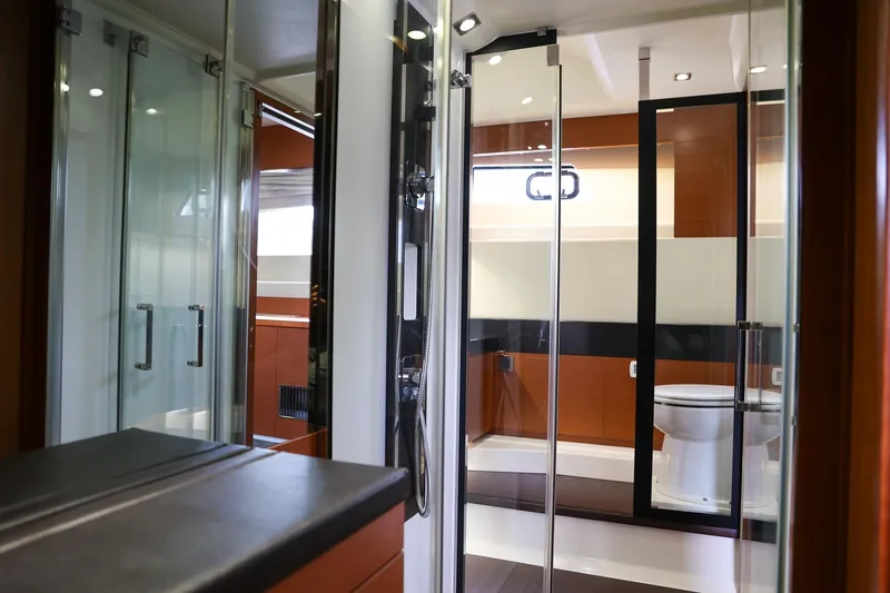  Yacht Photos Pics Luxurious bathroom interior of 2015 Prestige 520 yacht with modern fixtures and glass doors.