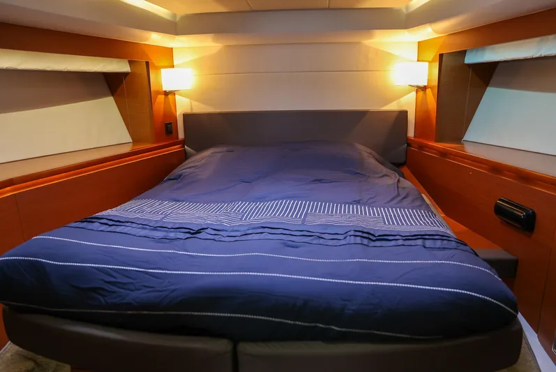  Yacht Photos Pics Luxurious cabin interior of 2015 Prestige 520 yacht with cozy bed and ambient lighting.